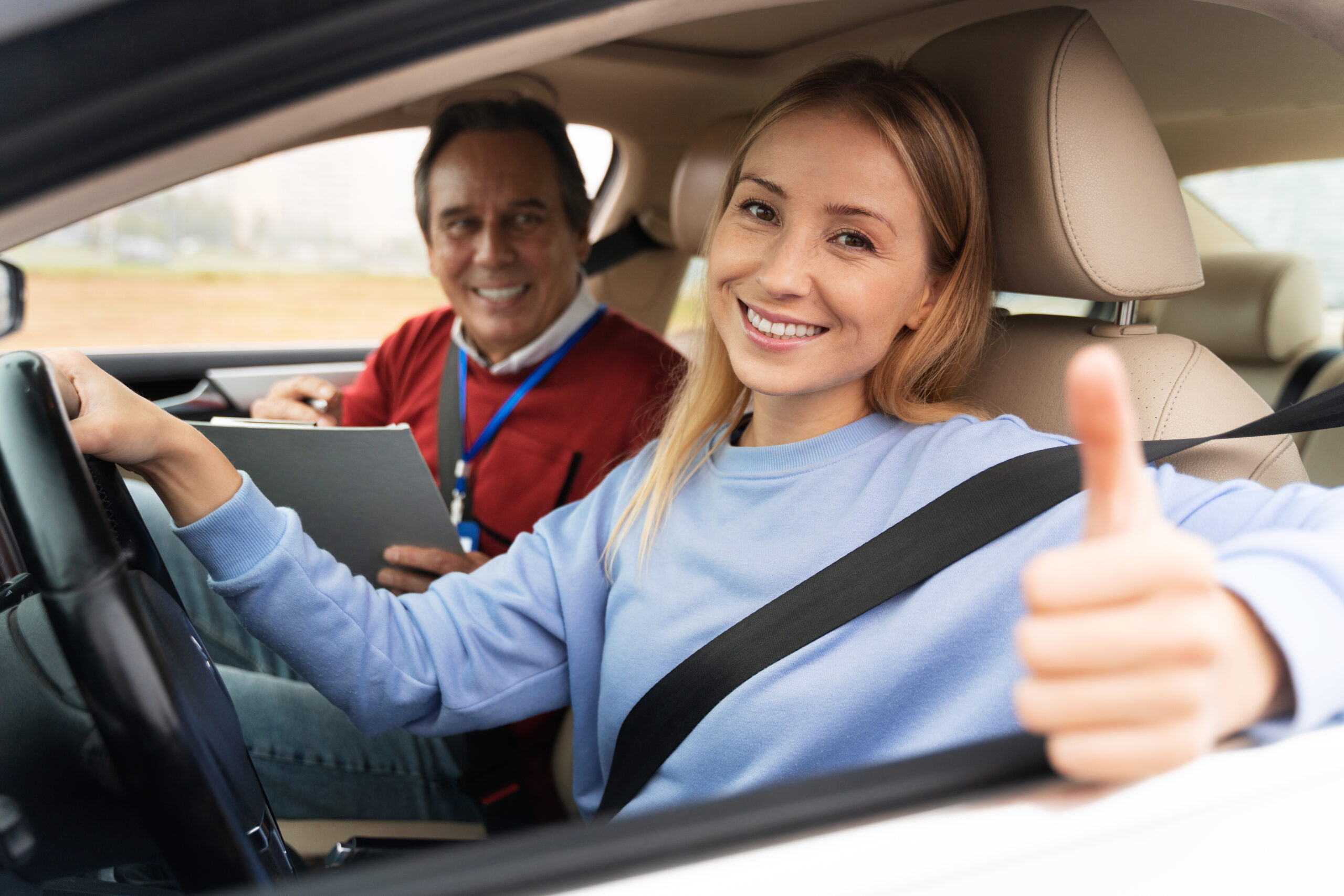 woman male driving instructor driving test scaled Projects